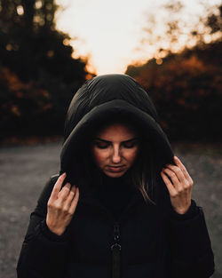 Portrait of young woman standing outdoors