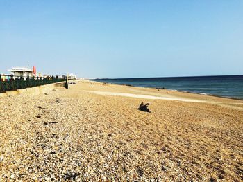 Scenic view of beach against clear sky