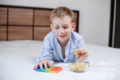 Portrait of boy sitting on table