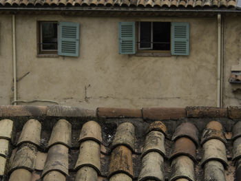 Close-up of old roof against building