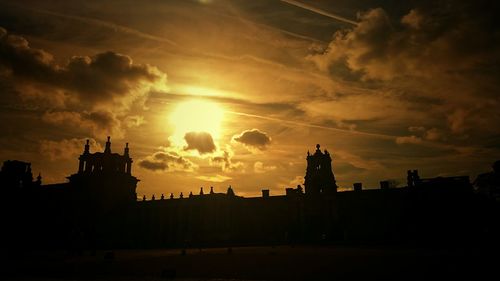 Low angle view of silhouette buildings against sky during sunset