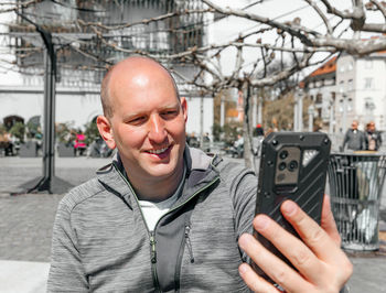 Portrait of a handsome hipster man. a man in a big city with smartphone, a life style concept