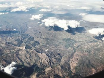 High angle view of sea and mountains against sky