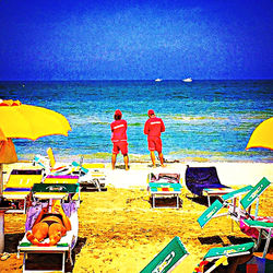 Rear view of people on beach