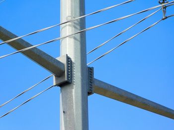 Low angle view of suspension bridge against clear blue sky