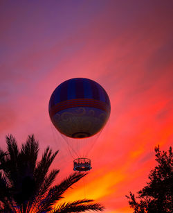 Low angle view of hot air balloon against orange sky