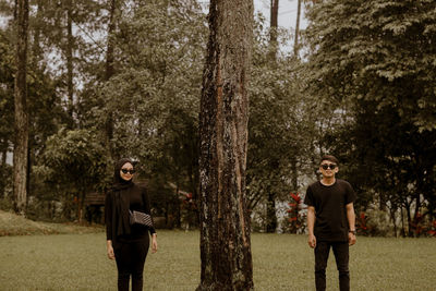 Full length of a man standing on tree trunk