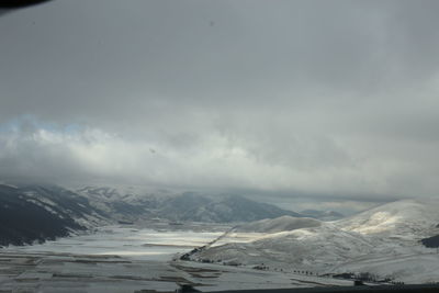 Scenic view of snowcapped mountains against sky