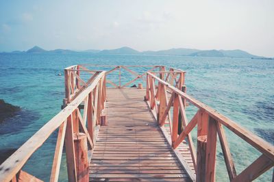 Pier over sea against sky