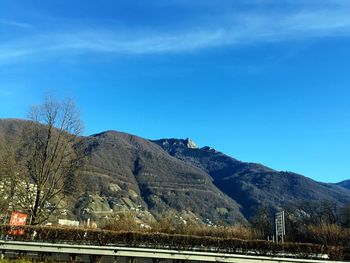 Scenic view of mountains against blue sky