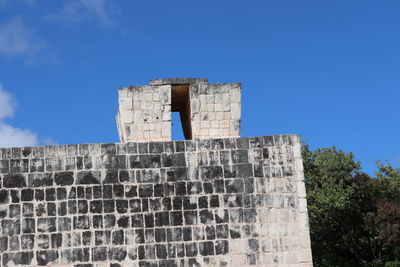 Low angle view of old building against blue sky