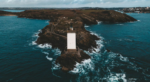 High angle view of lighthouse by sea against sky