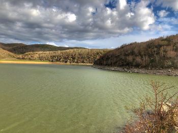 Scenic view of lake and mountains against sky