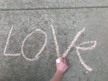High angle view of human hand on road