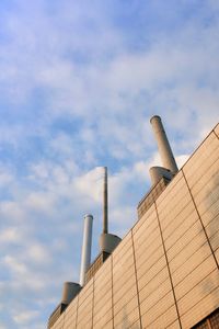 Low angle view of factory against sky