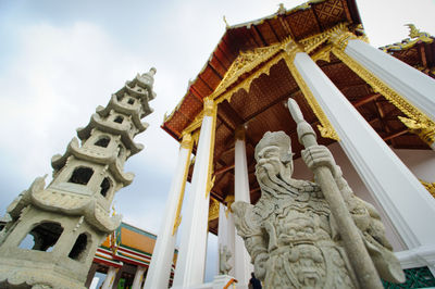 Low angle view of statue against temple building