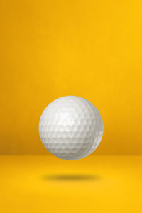 Close-up of ball on yellow background