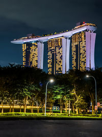 Illuminated modern building against sky at night