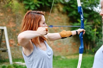 Close-up of woman practicing archery