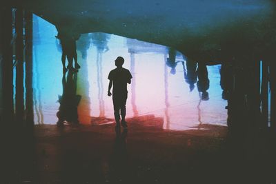 Silhouette man standing in sea