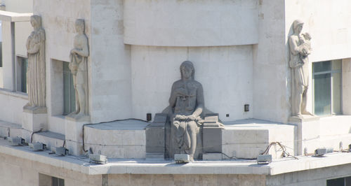 Statue against building