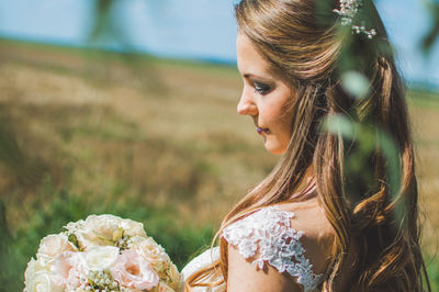 Close-up of bride with pink flowers