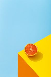 Close-up of orange slice against blue background