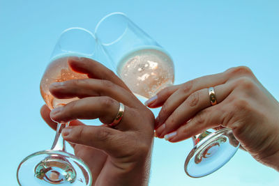 Low angle view of couple toasting champagne flutes 