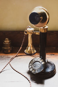 Old rotary phone on table