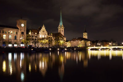 Reflection of illuminated buildings in city at night