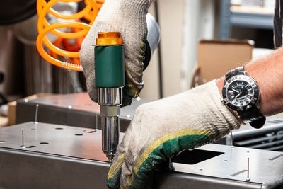 Cropped hand of man working in workshop