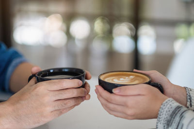 Close-up of hand holding coffee cup