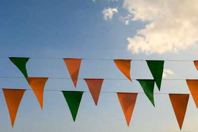 Low angle view of bunting flags against sky