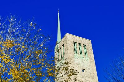 Low angle view of building against clear blue sky