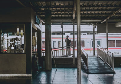 Rear view of man standing at subway station