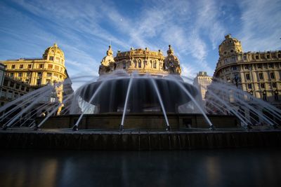 Low angle view of fountain building against sky