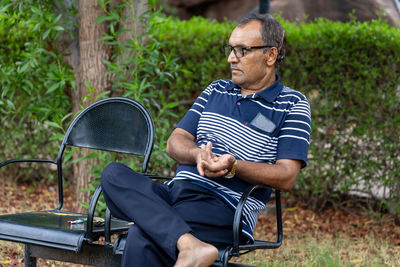 Man using tobacco closeup shot at outdoor park at evening from flat angle