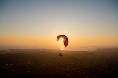 Scenic view of sunset over mountain against sky