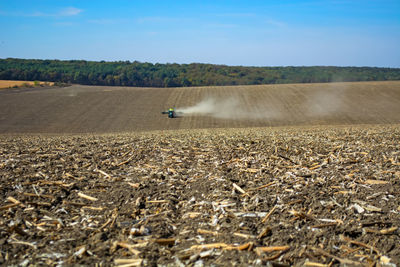 Scenic view of agricultural field against sky