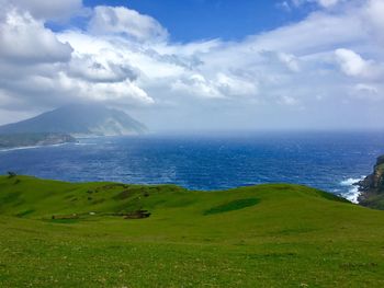 Scenic view of sea and mountains against sky