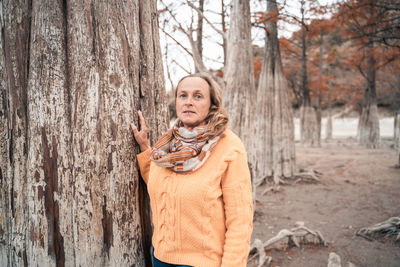 Portrait of a smiling young woman in forest