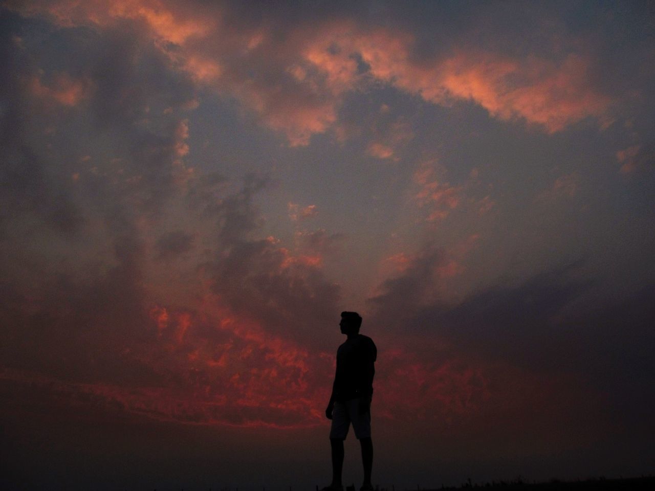 silhouette, sunset, real people, nature, sky, cloud - sky, standing, beauty in nature, one person, scenics, leisure activity, outdoors, tranquility, tranquil scene, full length, lifestyles, men, day, people