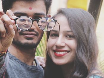 Reflection of smiling young couple in eyeglasses 