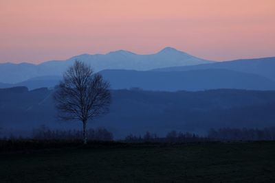 Scenic view of mountains against sky at sunset