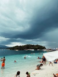 People on beach against sky