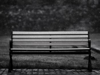 Empty bench in park during winter