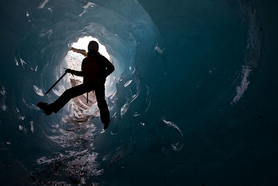 Woman exploring ice cave on sólheimajökull glacier in south iceland