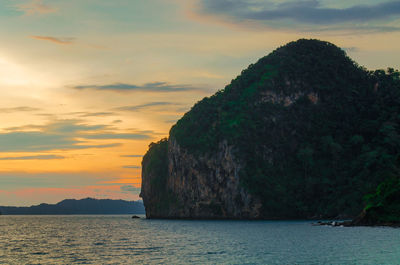 Scenic view of sea and mountains against sky