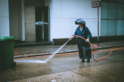 Full length of man standing by building