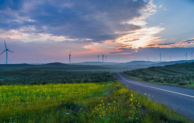 Scenic view of field against dramatic sky